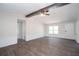 Open-concept living room featuring dark wood-look flooring, neutral paint, and ample natural light at 56 Windom Dr, Carrollton, GA 30116