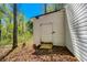 Exterior shed with weathered siding and small wooden deck, providing outdoor storage surrounded by trees at 56 Windom Dr, Carrollton, GA 30116