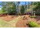 Tranquil backyard with a hammock between mature trees and landscaping at 602 Redbud Ter, Canton, GA 30115