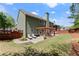 Green backyard featuring a patio with a pergola, seating, and mature trees at 602 Redbud Ter, Canton, GA 30115