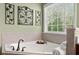 Close up of a luxurious soaking tub in a bright bathroom at 602 Redbud Ter, Canton, GA 30115