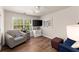 Bedroom with comfortable seating, natural light and hardwood floors at 602 Redbud Ter, Canton, GA 30115
