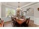 Dining room with a chandelier, wooden table set, and trim detail at 602 Redbud Ter, Canton, GA 30115