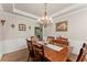 Dining room with decorative chandelier, wooden table set, and bright decor at 602 Redbud Ter, Canton, GA 30115