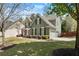 Beautiful home exterior featuring manicured lawn, lush shrubbery, and a two-car garage at 602 Redbud Ter, Canton, GA 30115
