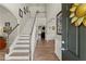 Bright foyer with hardwood floors, staircase, and view into the living spaces at 602 Redbud Ter, Canton, GA 30115