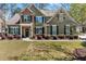 Charming two-story home with a stone accent wall, landscaped yard, and manicured lawn at 602 Redbud Ter, Canton, GA 30115