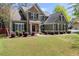 Inviting home exterior showcasing manicured lawn, shrubbery, and neutral paint at 602 Redbud Ter, Canton, GA 30115