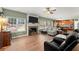 Open-concept living room with hardwood floors, fireplace, and lots of seating at 602 Redbud Ter, Canton, GA 30115