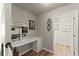 Bright office space with built-in shelving and desk, leading to laundry room at 602 Redbud Ter, Canton, GA 30115