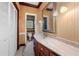 Bathroom featuring a vanity with mirror, wood walls and cabinets, and a toilet at 6048 Kings Mountain Way, Tucker, GA 30087
