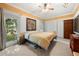 Bedroom featuring a ceiling fan, an area rug, two windows, and decorative wall art at 6048 Kings Mountain Way, Tucker, GA 30087