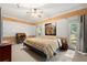 Bedroom featuring a ceiling fan, an area rug, two windows, and decorative wall art at 6048 Kings Mountain Way, Tucker, GA 30087