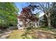 Captivating two-story home with dormer windows and a well-maintained yard with brick driveway and lush foliage at 6048 Kings Mountain Way, Tucker, GA 30087