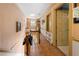 Hallway with hardwood floors and wood banister leading to the upper level at 6048 Kings Mountain Way, Tucker, GA 30087