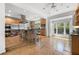 Kitchen featuring stainless steel appliances, an island with seating, and a sunlit window over the sink at 6048 Kings Mountain Way, Tucker, GA 30087