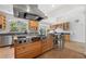 Gourmet kitchen with stainless steel appliances, a large island with seating, and custom cabinetry at 6048 Kings Mountain Way, Tucker, GA 30087