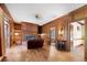 Cozy living room featuring wood-paneled walls, hardwood floors, a fireplace, and built-in bookshelves at 6048 Kings Mountain Way, Tucker, GA 30087
