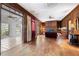 Inviting living room with wood-paneled walls, hardwood floors, a fireplace, and views into a sunroom at 6048 Kings Mountain Way, Tucker, GA 30087