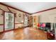 Spacious living room with hardwood floors, large windows, and red trim at 6048 Kings Mountain Way, Tucker, GA 30087