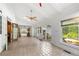 Airy sunroom featuring tile floors, multiple windows, fan, and French doors that offer seamless indoor-outdoor living at 6048 Kings Mountain Way, Tucker, GA 30087
