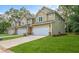 A row of new townhomes showcasing well-maintained lawns, two-car garages, and modern architectural details at 6884 Robinson St, Lithonia, GA 30058