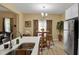 Eat-in kitchen with stainless appliances, bright cabinetry and breakfast bar extending from the kitchen at 6884 Robinson St, Lithonia, GA 30058
