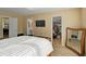Spacious bedroom with walk-in closet, mounted TV, and easy access to bathroom at 6884 Robinson St, Lithonia, GA 30058