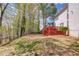A large backyard features a deck, trees, and greenery perfect for outdoor activities and relaxation at 725 Martin Field Dr, Lawrenceville, GA 30045