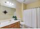 Bathroom with a combination of tile and yellow walls at 725 Martin Field Dr, Lawrenceville, GA 30045
