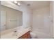 Simple, clean bathroom with a single sink, shower-tub combo, and white tile surround at 725 Martin Field Dr, Lawrenceville, GA 30045