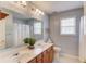 Bathroom with a double vanity, shower with curtain, toilet, and window with natural light at 725 Martin Field Dr, Lawrenceville, GA 30045
