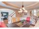 Stylish dining room showcasing open access to an office, living area, and staircase to upper level at 725 Martin Field Dr, Lawrenceville, GA 30045