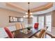 Dining room with modern chandelier, designer paint, mirror accent, and several windows for natural light at 725 Martin Field Dr, Lawrenceville, GA 30045