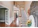 Bright two-story foyer with hardwood floors and staircase, plus decorative white trim and french doors at 725 Martin Field Dr, Lawrenceville, GA 30045