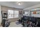 A well-equipped home gym features an elliptical machine, weights, and mirrored wall at 725 Martin Field Dr, Lawrenceville, GA 30045