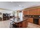 Open kitchen and living room area with island and black bar stools at 725 Martin Field Dr, Lawrenceville, GA 30045