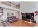 Open-concept living area featuring soaring ceilings, hardwood floors, and view of second-story landing at 725 Martin Field Dr, Lawrenceville, GA 30045