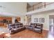 Open-concept living space featuring hardwood floors, natural lighting, and access to kitchen and front entry at 725 Martin Field Dr, Lawrenceville, GA 30045