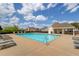 Community pool with blue water, lots of lounge chairs, and adjacent clubhouse on a sunny day at 725 Martin Field Dr, Lawrenceville, GA 30045