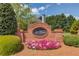 A brick sign at the entrance to St. Martin community with colorful flowers in front at 725 Martin Field Dr, Lawrenceville, GA 30045
