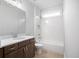 Bright bathroom featuring a shower-tub combination and a dark wood vanity with a white countertop at 1010 Coleman Place Dr, Roswell, GA 30075