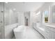 Bright bathroom with marble flooring, a standalone tub, and a walk-in shower at 1010 Coleman Place Dr, Roswell, GA 30075