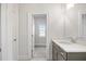 Bathroom featuring a quartz countertop, modern cabinets, and a doorway at 1010 Coleman Place Dr, Roswell, GA 30075