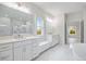 Bright bathroom features a soaking tub and glass enclosed shower, and double sinks at 1010 Coleman Place Dr, Roswell, GA 30075
