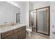 Stylish bathroom featuring a glass shower, granite countertop and a tile floor at 1010 Coleman Place Dr, Roswell, GA 30075