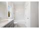 Bright bathroom features white tile, a shower-tub combo, and stylish fixtures at 1010 Coleman Place Dr, Roswell, GA 30075