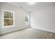 Well-lit bedroom with carpet flooring and views through two windows at 1010 Coleman Place Dr, Roswell, GA 30075
