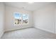 Bright, carpeted bedroom with a double window offering plenty of natural light at 1010 Coleman Place Dr, Roswell, GA 30075