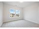 Bright bedroom featuring large windows, neutral paint, and soft carpet flooring at 1010 Coleman Place Dr, Roswell, GA 30075
